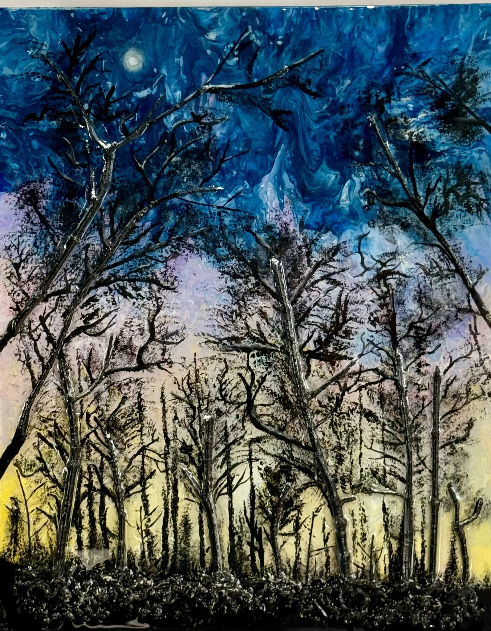 Bare winter trees painted in glossy black against a marbled night sky. Deep cobalt fills the top, a small pale moon low in the left, and the colour drops through violet and rose to a warm yellow glow at the horizon. A dense black tangle of undergrowth runs along the bottom edge. Heavily textured, almost wet looking.