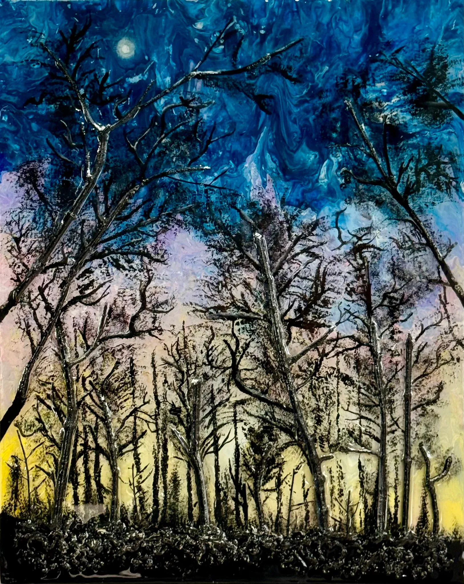 Bare winter trees in black silhouette against a sky that shifts from deep cobalt at the top, through lilac and rose, down to a band of pale yellow at the horizon. A small white moon hangs at the upper left. The trunks are built up in thick ridges of paint, and a dark crusted mass of undergrowth runs along the bottom edge. Still, cold and hushed.