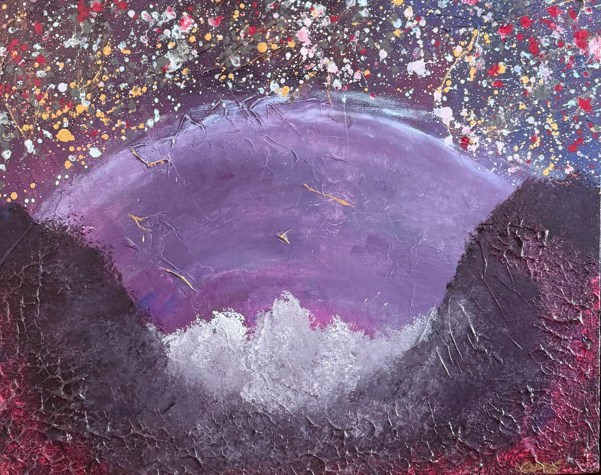 A large violet dome rises between two dark, deeply cracked banks of heavy textured paint, with white foam breaking at its base. The upper corners are flecked with spattered white, red, orange and gold like a starfield. Otherworldly, quiet, vast.